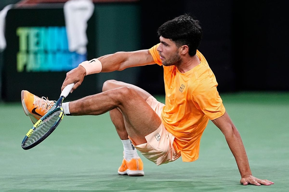 Carlos Alcaraz gets back up after falling backwards during a BNP Paribas Open third-round match against Arthur Rinderknech on Stadium 1 at the Indian Wells Tennis Garden in Indian Wells, Calif., on Monday, March 9, 2026.