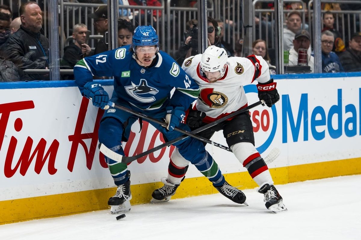 Mar 9, 2026; Vancouver, British Columbia, CAN; Ottawa Senators defenseman Nick Jensen (3) battles with Vancouver Canucks forward Curtis Douglas (42) in the second period at Rogers Arena. Mandatory Credit: Bob Frid-Imagn Images
