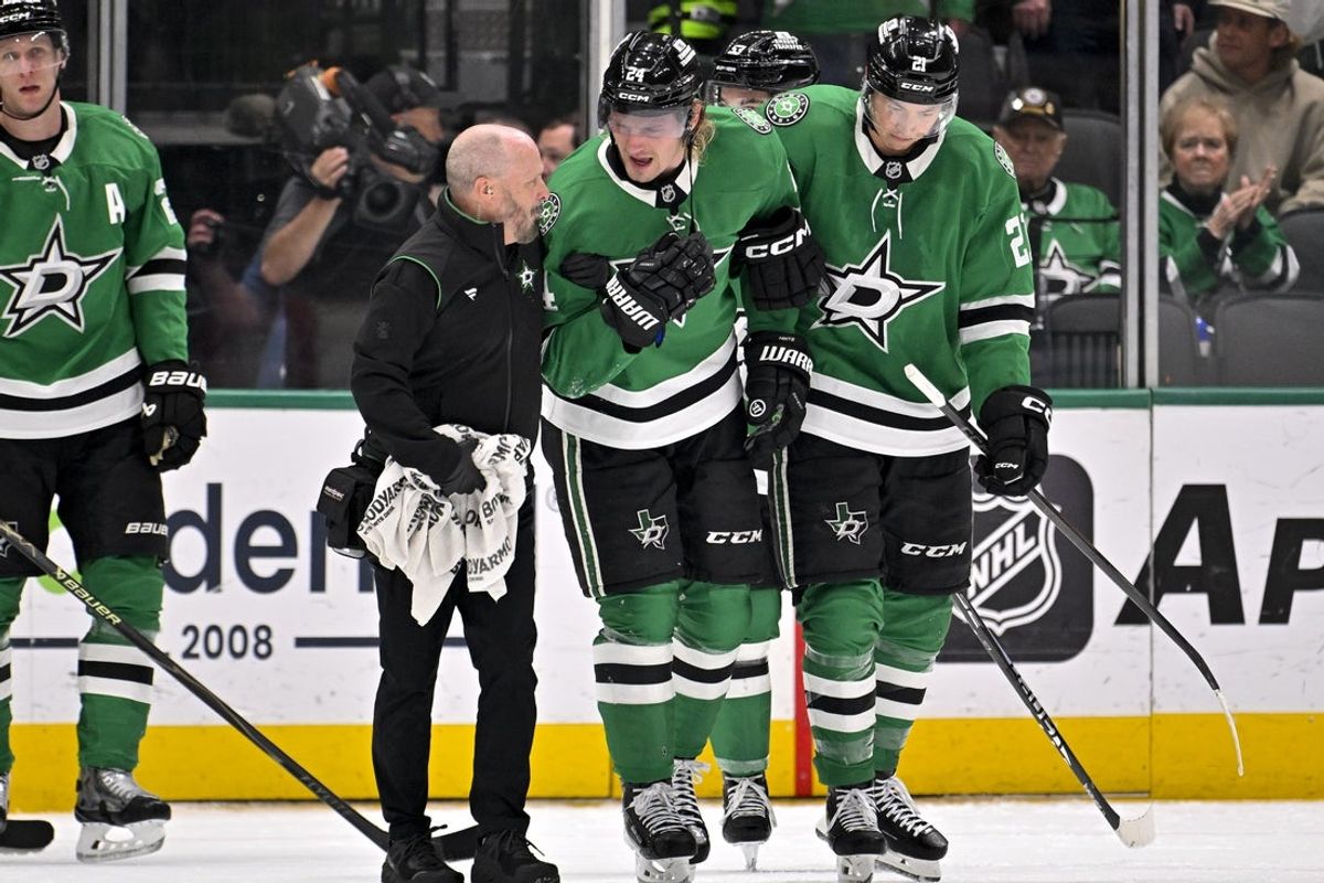 Mar 6, 2026; Dallas, Texas, USA; Dallas Stars center Roope Hintz (24) is helped off the ice by left wing Jason Robertson (21) after being injured during the game between the Stars and the Avalanche at American Airlines Center. Mandatory Credit: Jerome Miron-Imagn Images