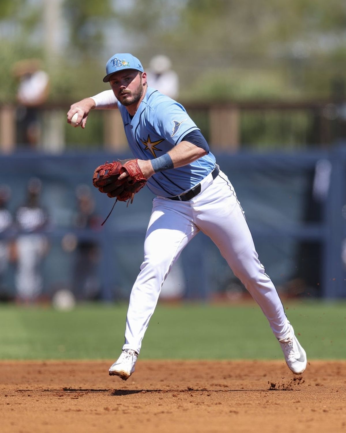 Mar 10, 2026; Port Charlotte, Florida, USA; Tampa Bay Rays second baseman Gavin Lux (11) throws to first few an out against the Minnesota Twins in the second inning during spring training at Charlotte Sports Park. Mandatory Credit: Nathan Ray Seebeck-Imagn Images