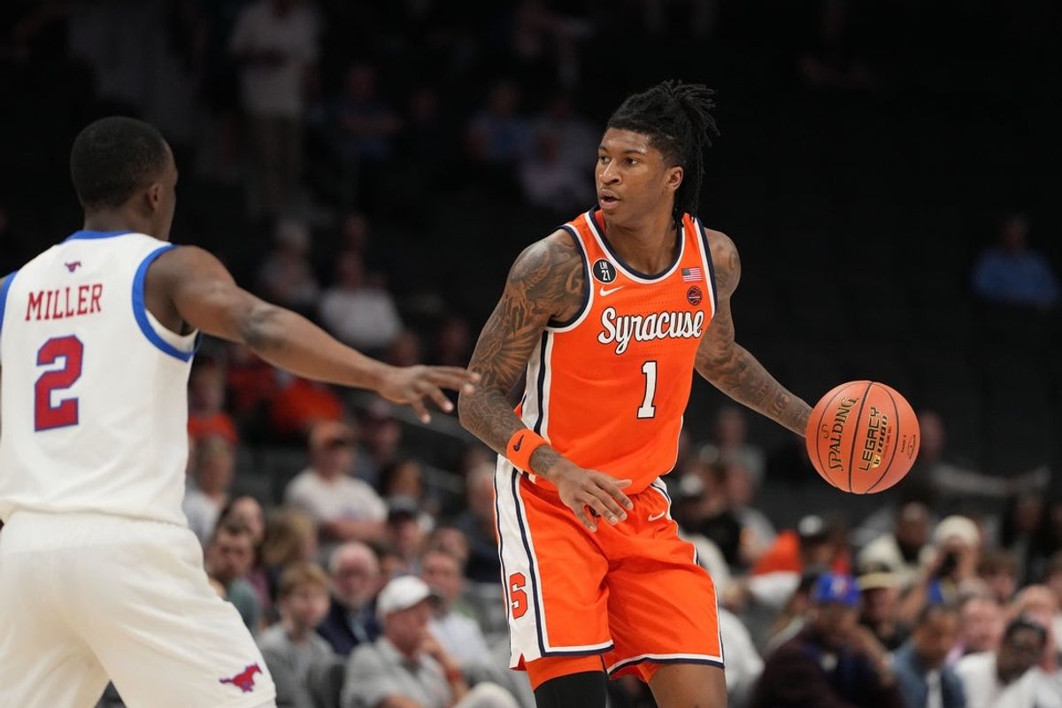 Mar 10, 2026; Charlotte, NC, USA; Syracuse Orange forward Donnie Freeman (1) with the ball as Southern Methodist University Mustangs guard Boopie Miller (2) defends in the first half at Spectrum Center. Mandatory Credit: Bob Donnan-Imagn Images