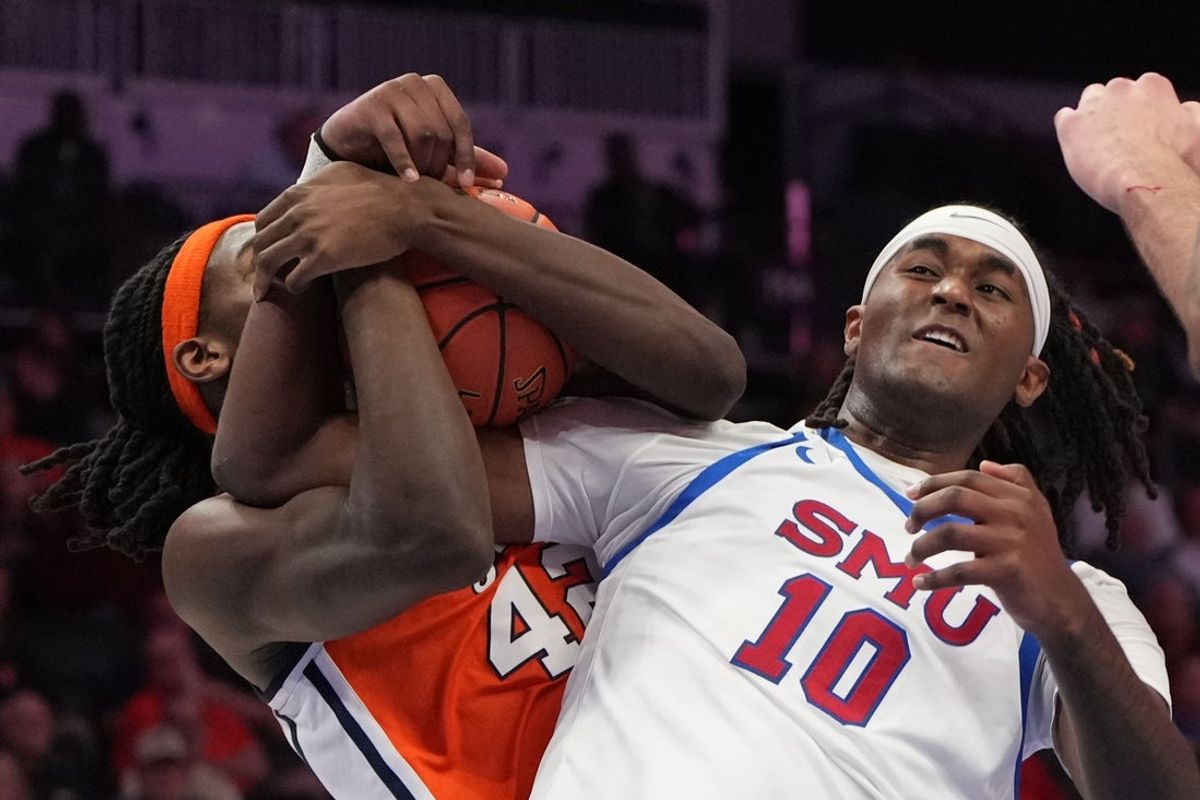 Mar 10, 2026; Charlotte, NC, USA; Syracuse Orange forward William Kyle III (42) and Southern Methodist University Mustangs center Jaden Toombs (10) fight for the ball in the first half at Spectrum Center. Mandatory Credit: Bob Donnan-Imagn Images