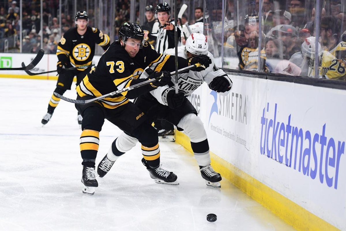Mar 10, 2026; Boston, Massachusetts, USA;  Boston Bruins defenseman Charlie McAvoy (73) and Los Angeles Kings center Alex Turcotte (15) battle for the puck during the second period at TD Garden. Mandatory Credit: Bob DeChiara-Imagn Images