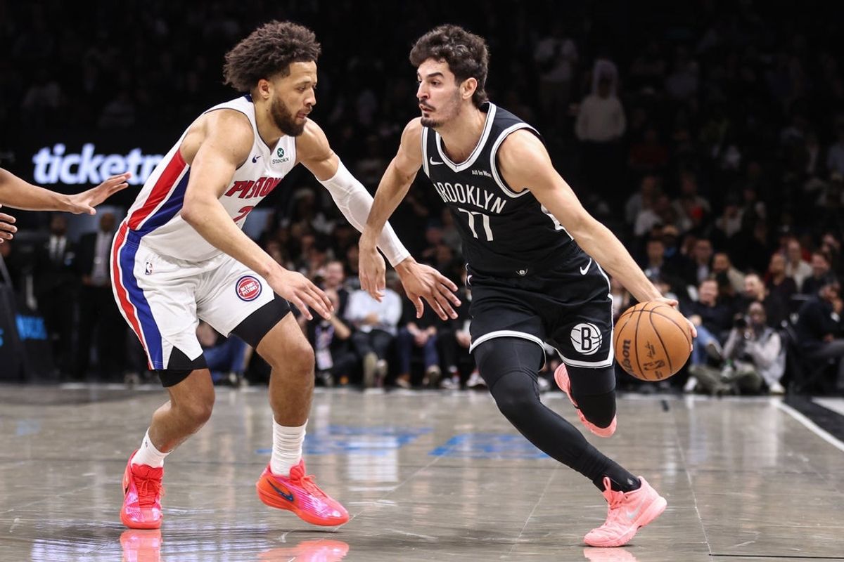 Mar 10, 2026; Brooklyn, New York, USA;  Brooklyn Nets guard Ben Saraf (77) drives past Detroit Pistons guard Cade Cunningham (2) in the first quarter at Barclays Center. Mandatory Credit: Wendell Cruz-Imagn Images