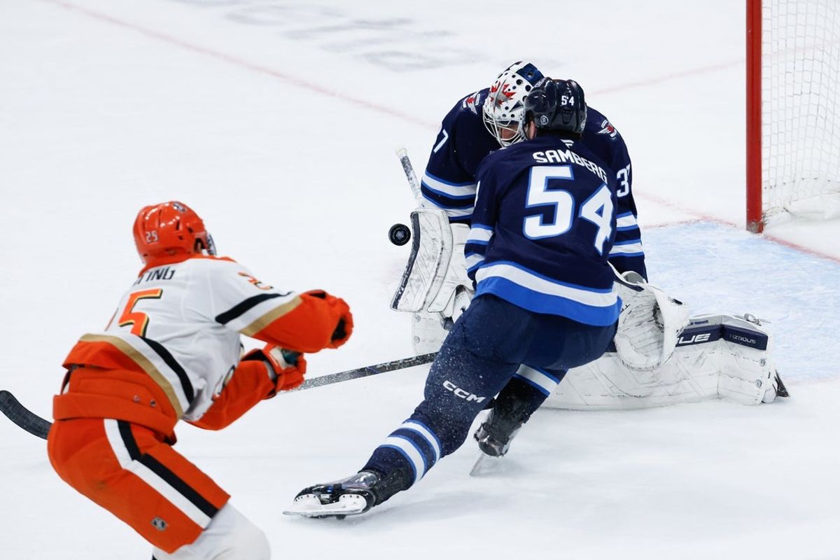 Mar 10, 2026; Winnipeg, Manitoba, CAN;  Winnipeg Jets goalie Connor Hellebuyck (37) makes a save on a shot by Anaheim Ducks forward Russ Poehling (25) during the first period at Canada Life Centre. Mandatory Credit: Terrence Lee-Imagn Images
