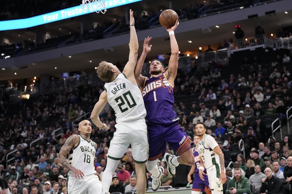 Mar 10, 2026; Milwaukee, Wisconsin, USA;  Phoenix Suns guard Devin Booker (1) shoots against Milwaukee Bucks guard AJ Green (20) during the third quarter at Fiserv Forum. Mandatory Credit: Jeff Hanisch-Imagn Images