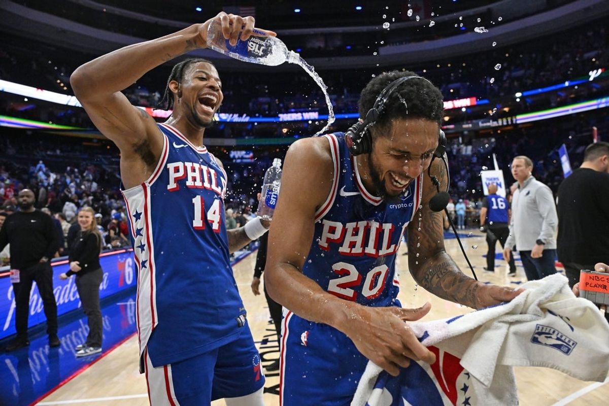 Mar 10, 2026; Philadelphia, Pennsylvania, USA; Philadelphia 76ers guard Cameron Payne (20) has water poured on him by forward Dalen Terry (14) after win against the Memphis Grizzlies at Xfinity Mobile Arena. Mandatory Credit: Eric Hartline-Imagn Images
