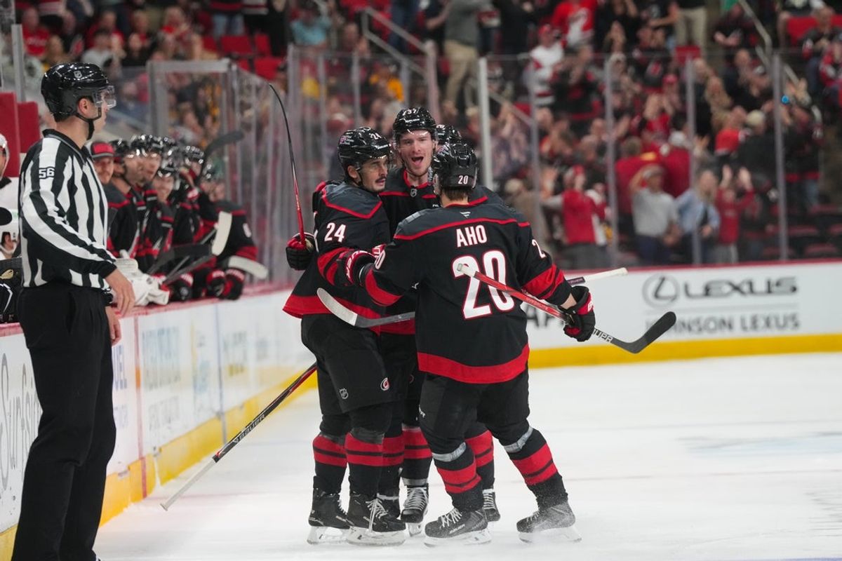 Mar 10, 2026; Raleigh, North Carolina, USA;  Carolina Hurricanes center Seth Jarvis (24) celebrates his goal with right wing Andrei Svechnikov (37) and center Sebastian Aho (20)  goal against the Pittsburgh Penguins during the third period at Lenovo Center. Mandatory Credit: James Guillory-Imagn Images