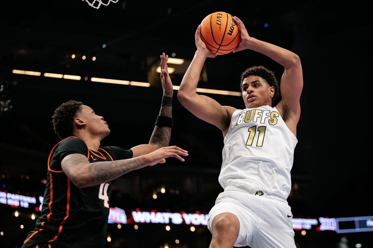 Mar 10, 2026; Kansas City, MO, USA; Colorado Buffaloes guard Jalin Holland (11) rebounds over Oklahoma State Cowboys guard Christian Coleman (4) during the first half at T-Mobile Center. Mandatory Credit: William Purnell-Imagn Images