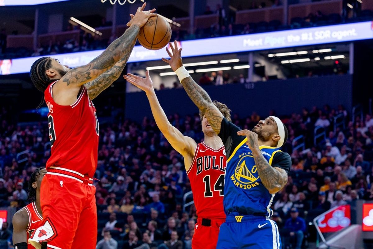 Mar 10, 2026; San Francisco, California, USA; Golden State Warriors guard Gary Payton II (0) fights for a rebound with Chicago Bulls center Nick Richards (13) during the second quarter at Chase Center. Mandatory Credit: Bob Kupbens-Imagn Images