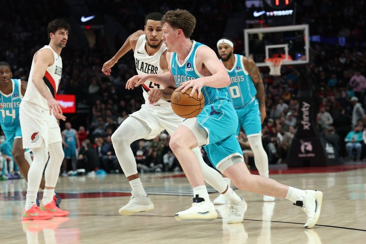Mar 10, 2026; Portland, Oregon, USA;  Charlotte Hornets guard/forward Kon Knueppel (7) drives to the basket against Portland Trail Blazers forward Kris Murray (24) during the first half at Moda Center. Mandatory Credit: Jaime Valdez-Imagn Images