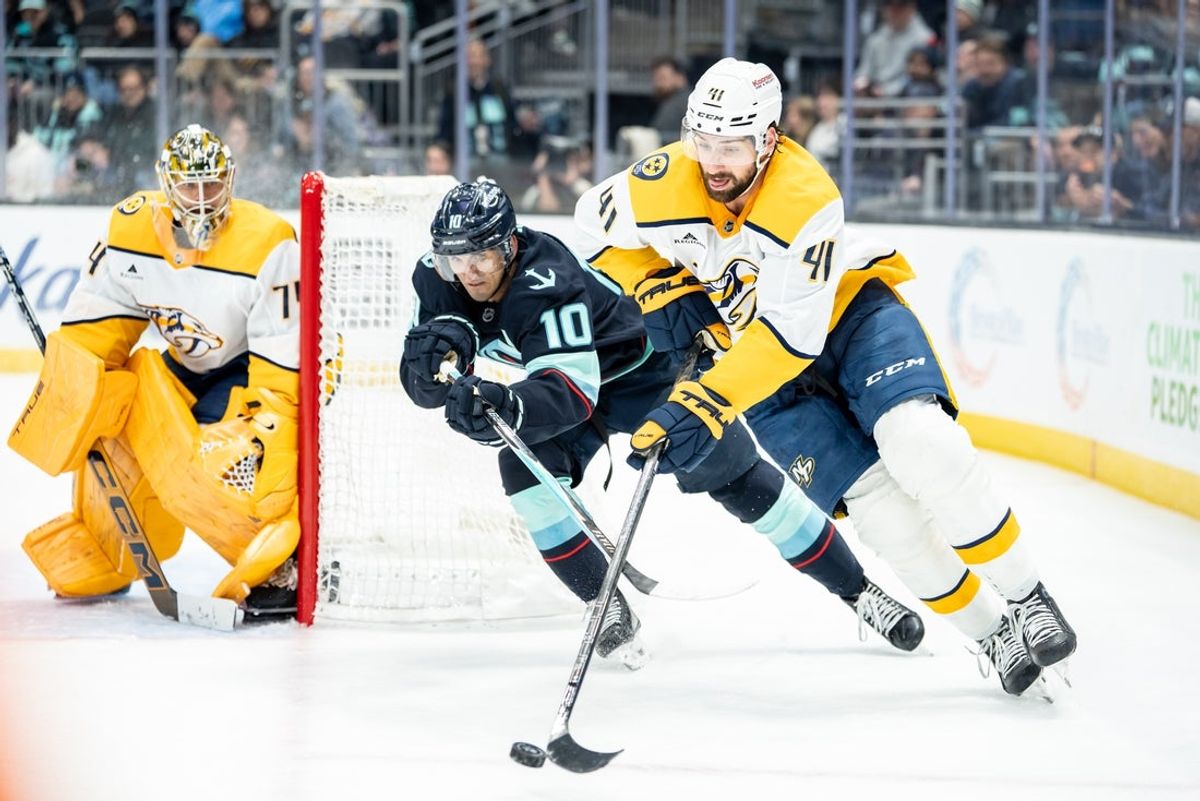Mar 10, 2026; Seattle, Washington, USA; Nashville Predators defenseman Nicolas Hague (41) and Seattle Kraken forward Matty Beniers (10) battle for the puck during the second period at Climate Pledge Arena. Mandatory Credit: Stephen Brashear-Imagn Images