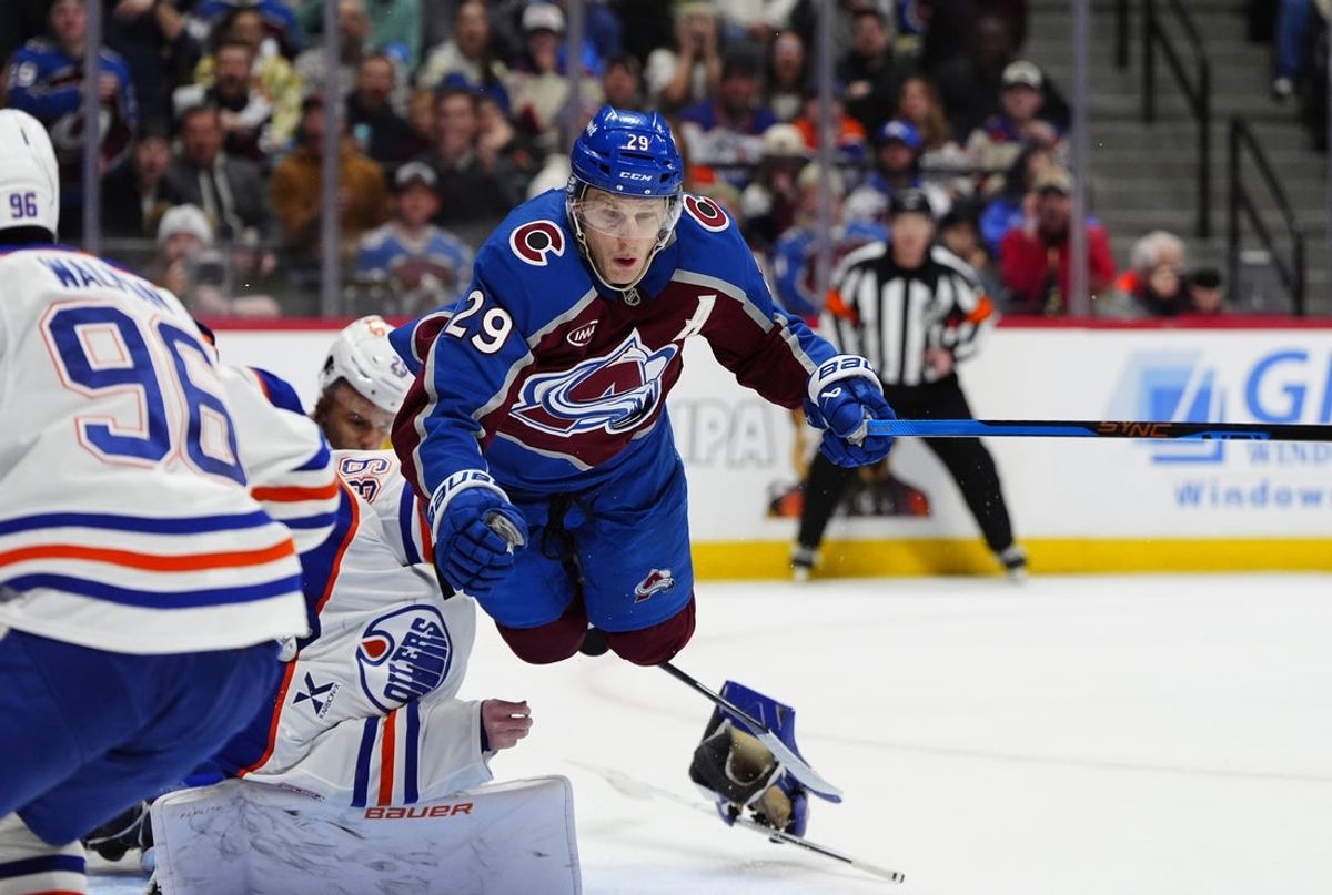Mar 10, 2026; Denver, Colorado, USA; Colorado Avalanche center Nathan MacKinnon (29) collides into Edmonton Oilers goaltender Connor Ingram (39) in the second period at Ball Arena. Mandatory Credit: Ron Chenoy-Imagn Images