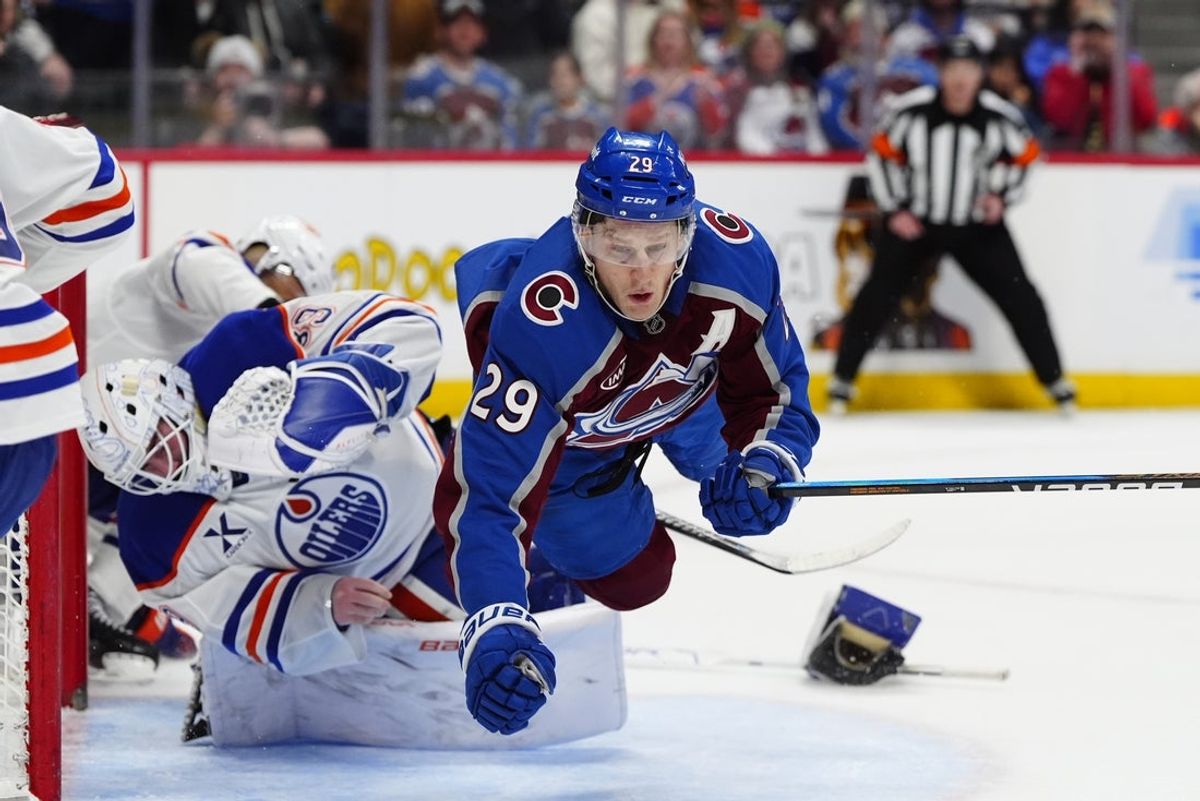Mar 10, 2026; Denver, Colorado, USA; Colorado Avalanche center Nathan MacKinnon (29) collides into Edmonton Oilers goaltender Connor Ingram (39) in the second period at Ball Arena. Mandatory Credit: Ron Chenoy-Imagn Images