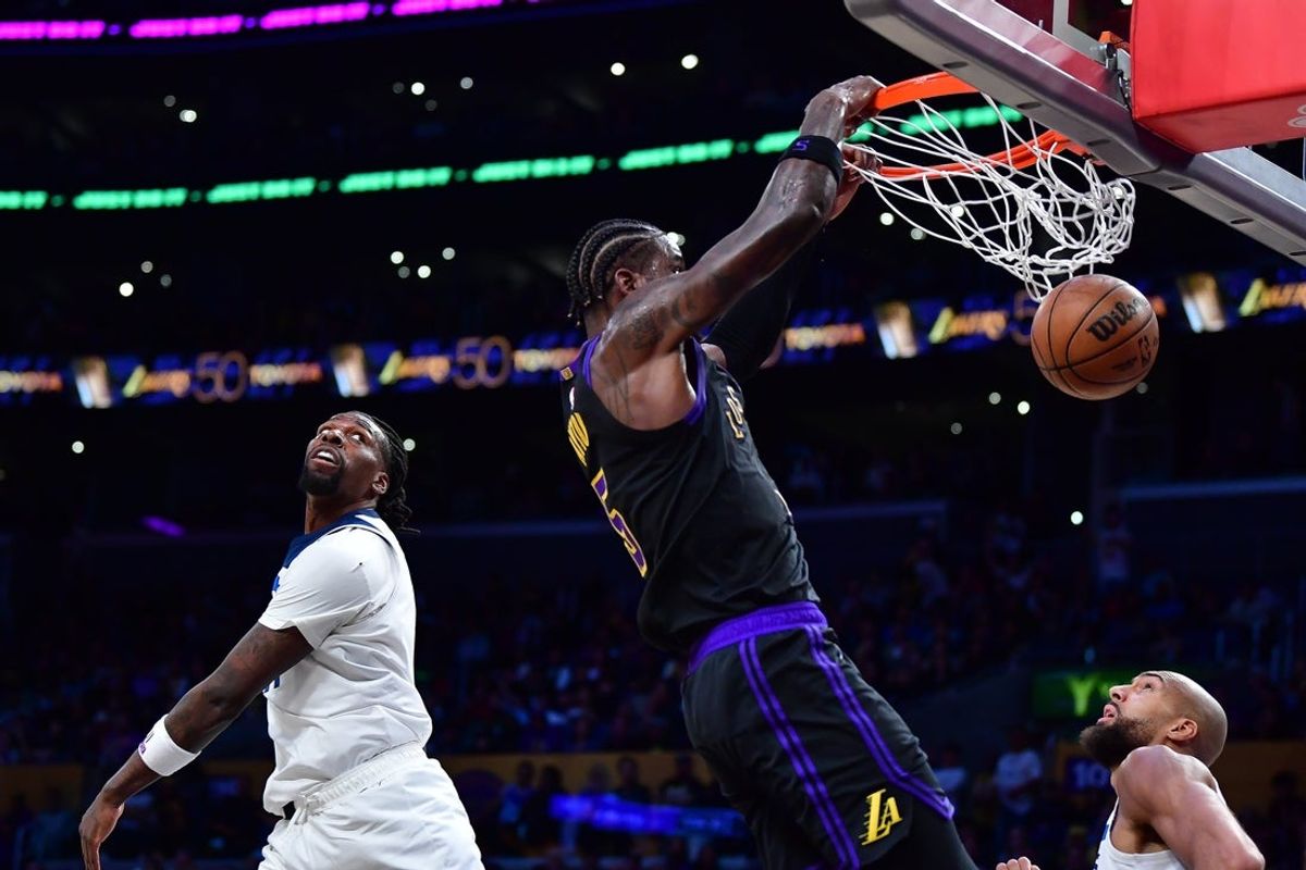 Mar 10, 2026; Los Angeles, California, USA; Los Angeles Lakers center Deandre Ayton (5) dunks for the basket against Minnesota Timberwolves center Naz Reid (11) and center Rudy Gobert (27) during the first half at Crypto.com Arena. Mandatory Credit: Gary A. Vasquez-Imagn Images