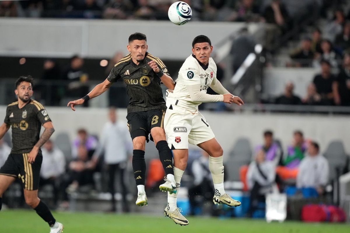 Mar 10, 2026; Los Angeles, California, USA; LAFC midfielder Mark Delgado (8) and LD Alajuelense midfielder Alejandro Bran (14) battle for the ball in the second half of Concacaf Champions Cup-Round of 16 game at BMO Stadium. Mandatory Credit: Kirby Lee-Imagn Images