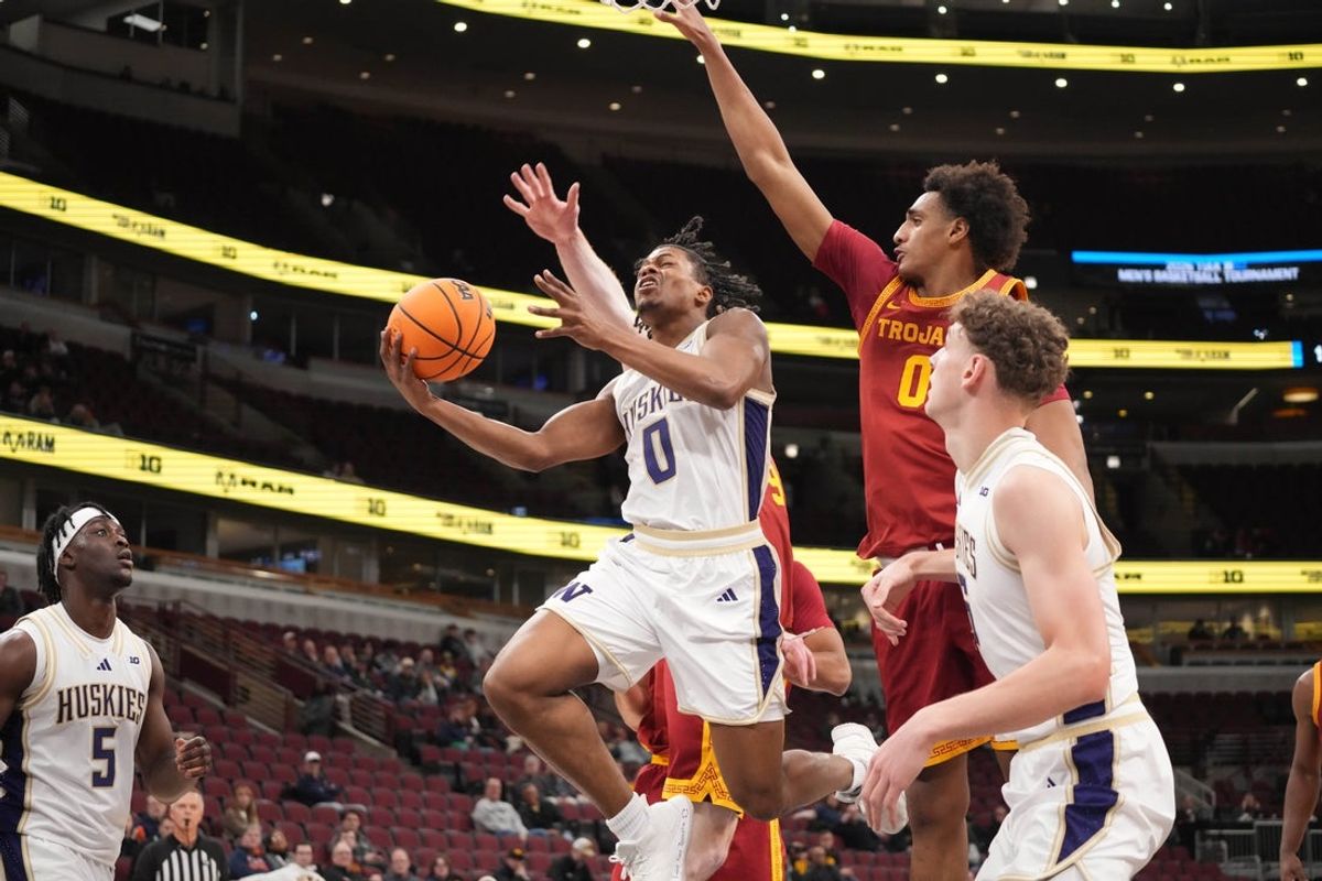 Mar 11, 2026; Chicago, IL, USA; Washington Huskies guard Quimari Peterson (0) is defended by Southern California Trojans guard Alijah Arenas (0) during the first half at United Center. Mandatory Credit: David Banks-Imagn Images