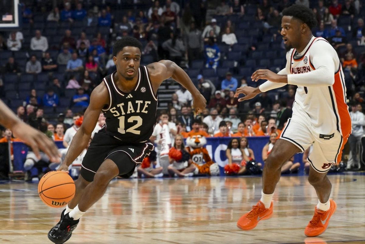 Mar 11, 2026; Nashville, TN, USA;  Mississippi State Bulldogs guard Josh Hubbard (12) dribbles past Auburn Tigers guard Kevin Overton (1) during the second half at Bridgestone Arena. Mandatory Credit: Steve Roberts-Imagn Images