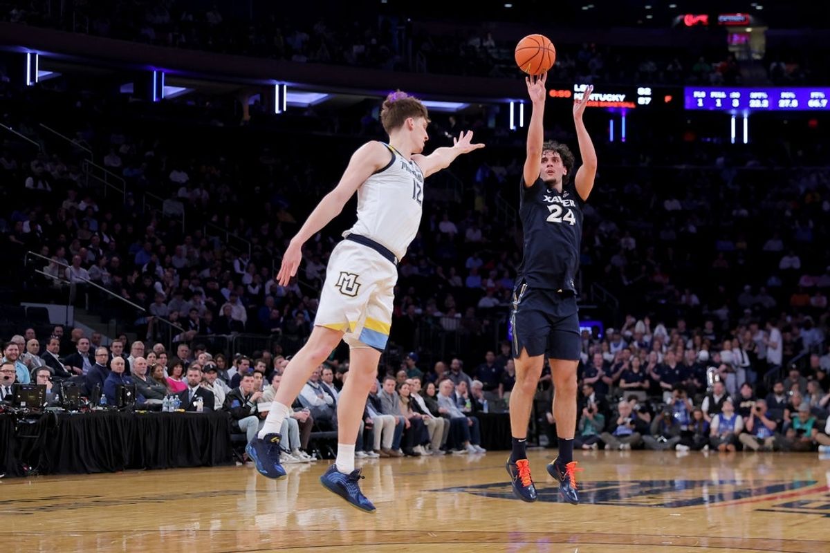 Mar 11, 2026; New York, NY, USA; Xavier Musketeers forward Jovan Milicevic (24) shoots a three point shot against Marquette Golden Eagles forward Ben Gold (12) during the first half at Madison Square Garden. Mandatory Credit: Brad Penner-Imagn Images