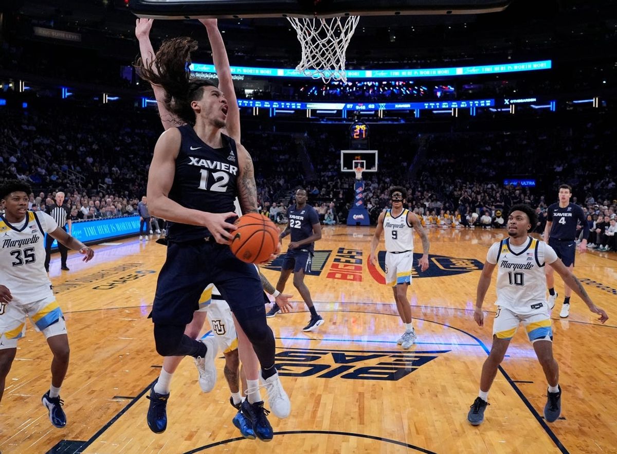 Mar 11, 2026; New York, NY, USA;  Xavier Musketeers forward Tre Carroll (12) drives against the Marquette Golden Eagles during the second half at Madison Square Garden. Mandatory Credit: Robert Deutsch-Imagn Images