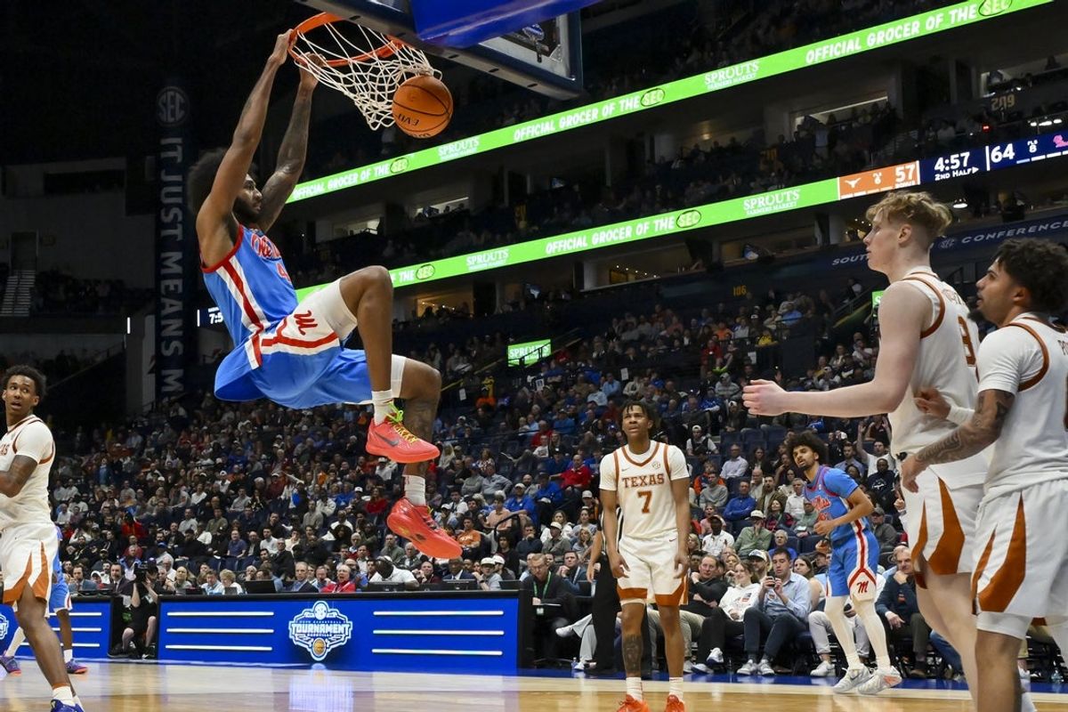 Mar 11, 2026; Nashville, TN, USA;  Mississippi Rebels forward James Scott (4) dunks the ball against the Texas Longhorns during the second half at Bridgestone Arena. Mandatory Credit: Steve Roberts-Imagn Images