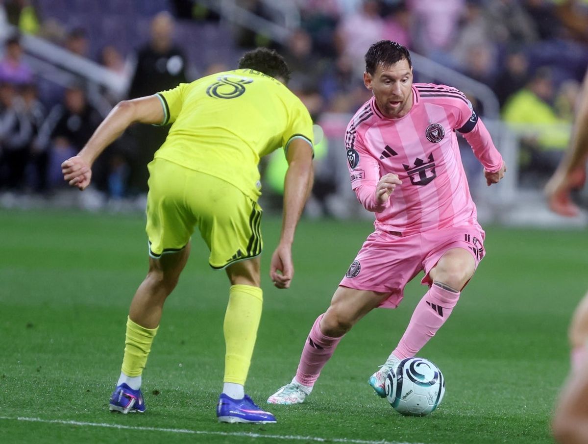 Mar 11, 2026; Nashville, Tennessee, USA; Inter Miami CF forward  Lionel Messi (10) attacks as Nashville SC midfielder Patrick Yazbek (8) defends during their 2026 Concacaf Champions Cup Round of 16 Leg 1 game at GEODIS Park. Mandatory Credit: Alan Poizner-Imagn Images