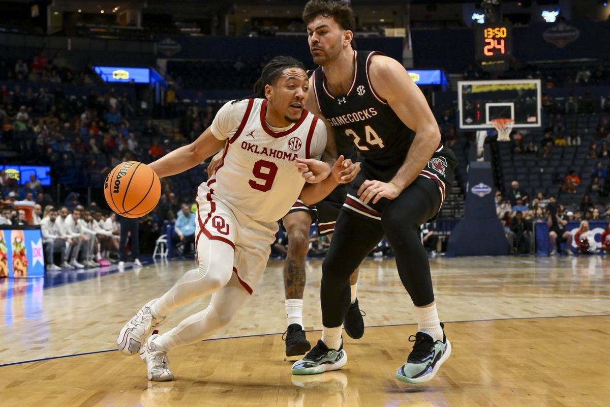 Mar 11, 2026; Nashville, TN, USA;  Oklahoma Sooners guard Nijel Pack (9) dribbles the ball past South Carolina Gamecocks forward Nordin Kapic (24) during the first half at Bridgestone Arena. Mandatory Credit: Steve Roberts-Imagn Images