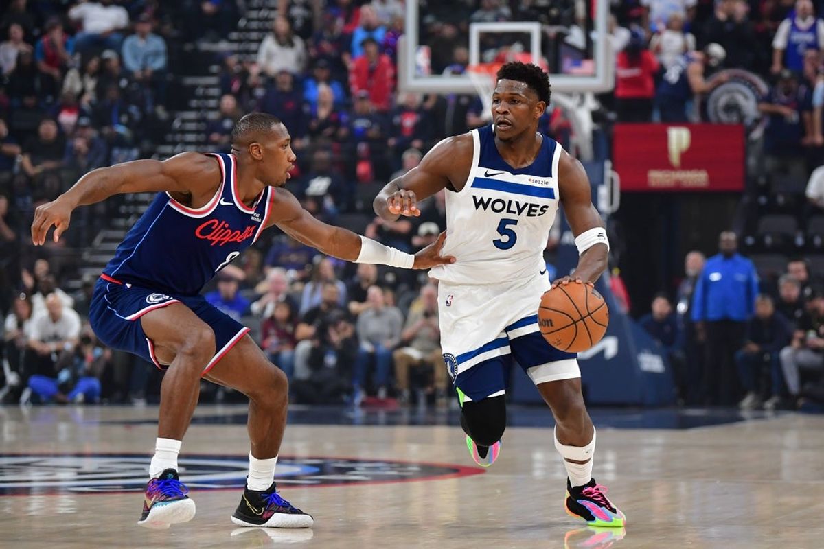 Mar 11, 2026; Inglewood, California, USA;  Minnesota Timberwolves guard Anthony Edwards (5) moves the ball against Los Angeles Clippers guard Kris Dunn (8) during the first half at Intuit Dome. Mandatory Credit: Gary A. Vasquez-Imagn Images