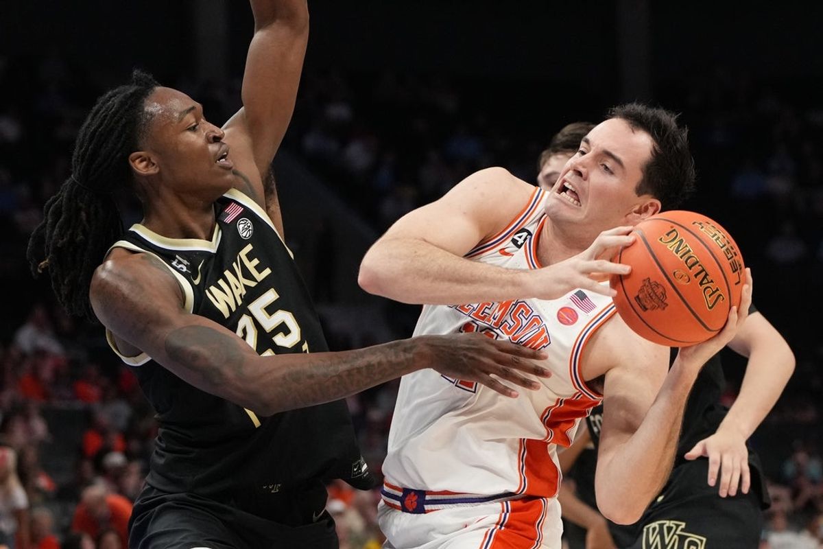 Mar 11, 2026; Charlotte, NC, USA; Clemson Tigers forward Nick Davidson (11) with the ball as Wake Forest Demon Deacons forward Tre'von Spillers (25) defends in the second half at Spectrum Center. Mandatory Credit: Bob Donnan-Imagn Images