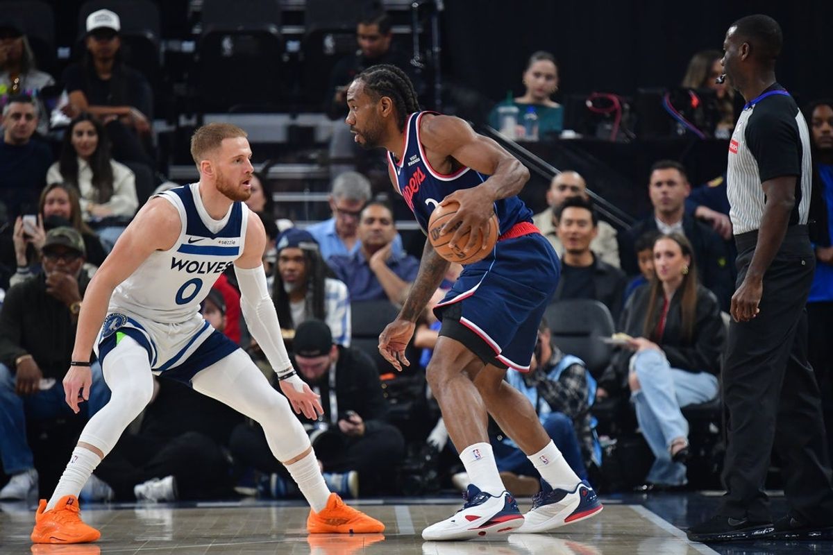 Mar 11, 2026; Inglewood, California, USA; Los Angeles Clippers forward Kawhi Leonard (2) controls the ball against Minnesota Timberwolves guard Donte DiVincenzo (0) during the first half at Intuit Dome. Mandatory Credit: Gary A. Vasquez-Imagn Images