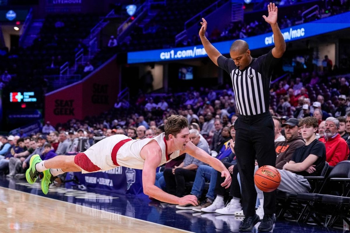 Miami RedHawks guard Peter Suder (5) dives after a loose ball in the first half of Mid-American Conference Tournament first round game between the Miami RedHawks and the UMass Minutemen at Rocket Arena in Cleveland on Thursday, March 12, 2026. Miami led 39-37 at halftime.