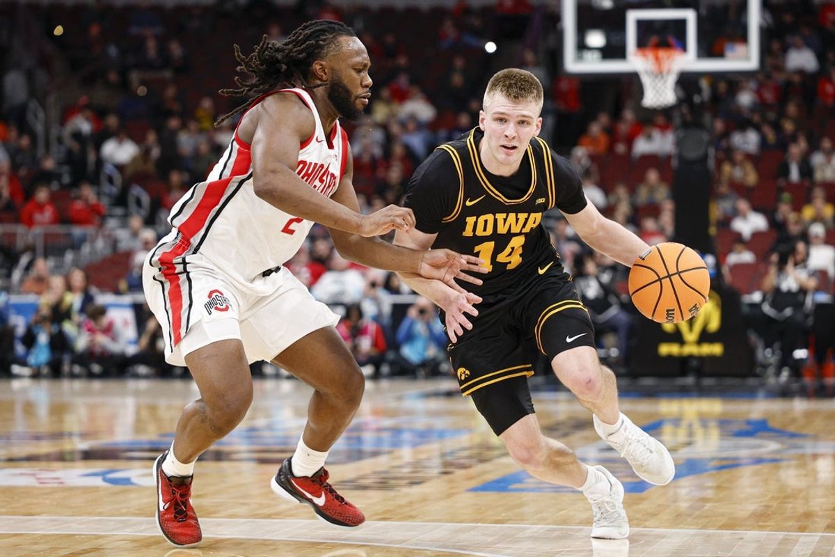 Mar 12, 2026; Chicago, IL, USA; Iowa Hawkeyes guard Bennett Stirtz (14) drives to the basket against Ohio State Buckeyes guard Bruce Thornton (2) during the first half at United Center. Mandatory Credit: Kamil Krzaczynski-Imagn Images