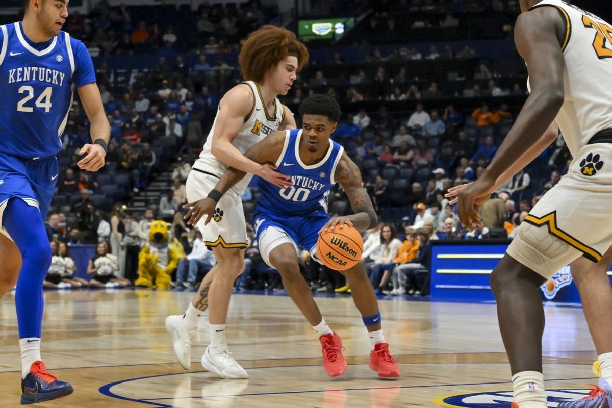 Mar 12, 2026; Nashville, TN, USA;  Kentucky Wildcats guard Otega Oweh (00) dribbles the ball past Missouri Tigers guard T.O. Barrett (5) during the second half at Bridgestone Arena. Mandatory Credit: Steve Roberts-Imagn Images