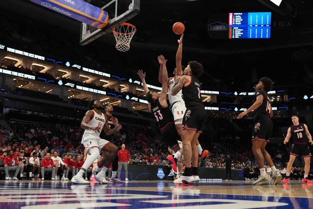 Mar 12, 2026; Charlotte, NC, USA; Miami (FL) Hurricanes forward Malik Reneau (5) goes to the basket against Louisville Cardinals forward Vangelis Zougris (53) uring the first half at Spectrum Center. Mandatory Credit: Jim Dedmon-Imagn Images