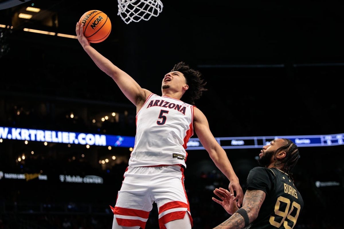 Mar 12, 2026; Kansas City, MO, USA; Arizona Wildcats guard Brayden Burries (5) shoots the ball over UCF Knights forward Jordan Burks (99) during the first half at T-Mobile Center. Mandatory Credit: William Purnell-Imagn Images