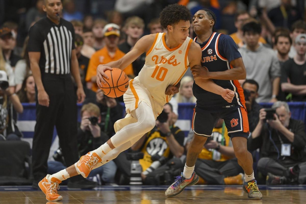 Mar 12, 2026; Nashville, TN, USA;  Tennessee Volunteers forward Nate Ament (10) dribbles the ball past Auburn Tigers guard Tahaad Pettiford (0) during the second half at Bridgestone Arena. Mandatory Credit: Steve Roberts-Imagn Images