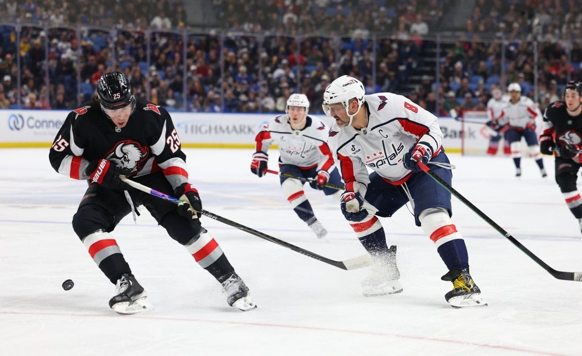 Mar 12, 2026; Buffalo, New York, USA;  Buffalo Sabres defenseman Owen Power (25) tries to block a pass by Washington Capitals left wing Alex Ovechkin (8) during the first period at KeyBank Center. Mandatory Credit: Timothy T. Ludwig-Imagn Images