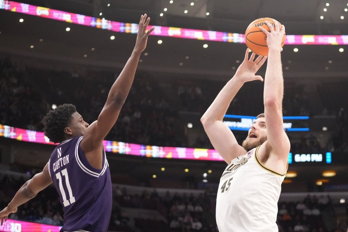 Mar 12, 2026; Chicago, IL, USA; Northwestern Wildcats guard Jordan Clayton (11) defends Purdue Boilermakers center Oscar Cluff (45) during the first half at United Center. Mandatory Credit: David Banks-Imagn Images