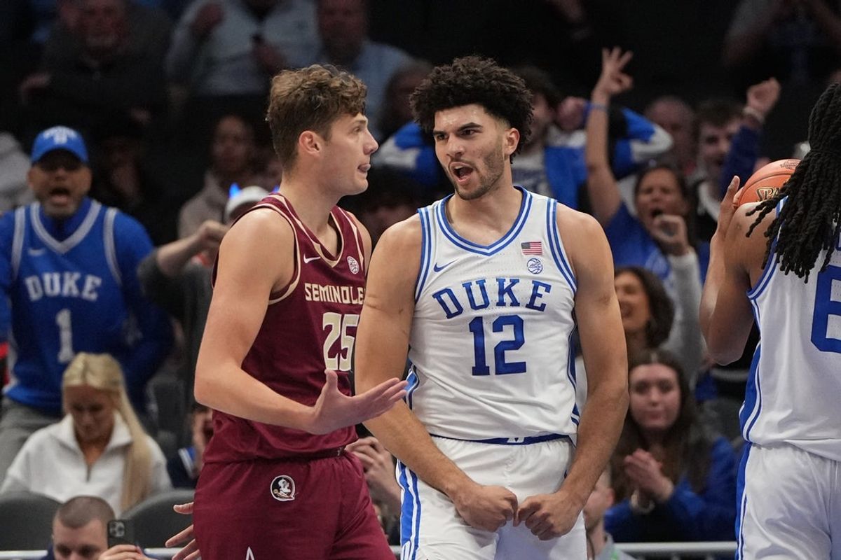 Mar 12, 2026; Charlotte, NC, USA; Duke Blue Devils forward Cameron Boozer (12) reacts after scoring as Florida State Seminoles forward Alex Steen (25) is in the foreground in the first half at Spectrum Center. Mandatory Credit: Bob Donnan-Imagn Images
