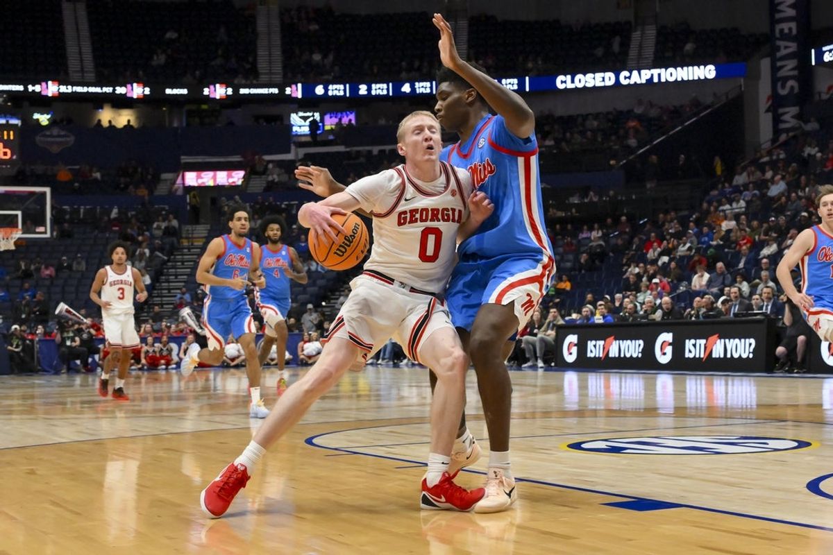 Mar 12, 2026; Nashville, TN, USA;  Georgia Bulldogs guard Blue Cain (0) dribbles into the chest of Mississippi Rebels forward Malik Dia (0) during the first half at Bridgestone Arena. Mandatory Credit: Steve Roberts-Imagn Images