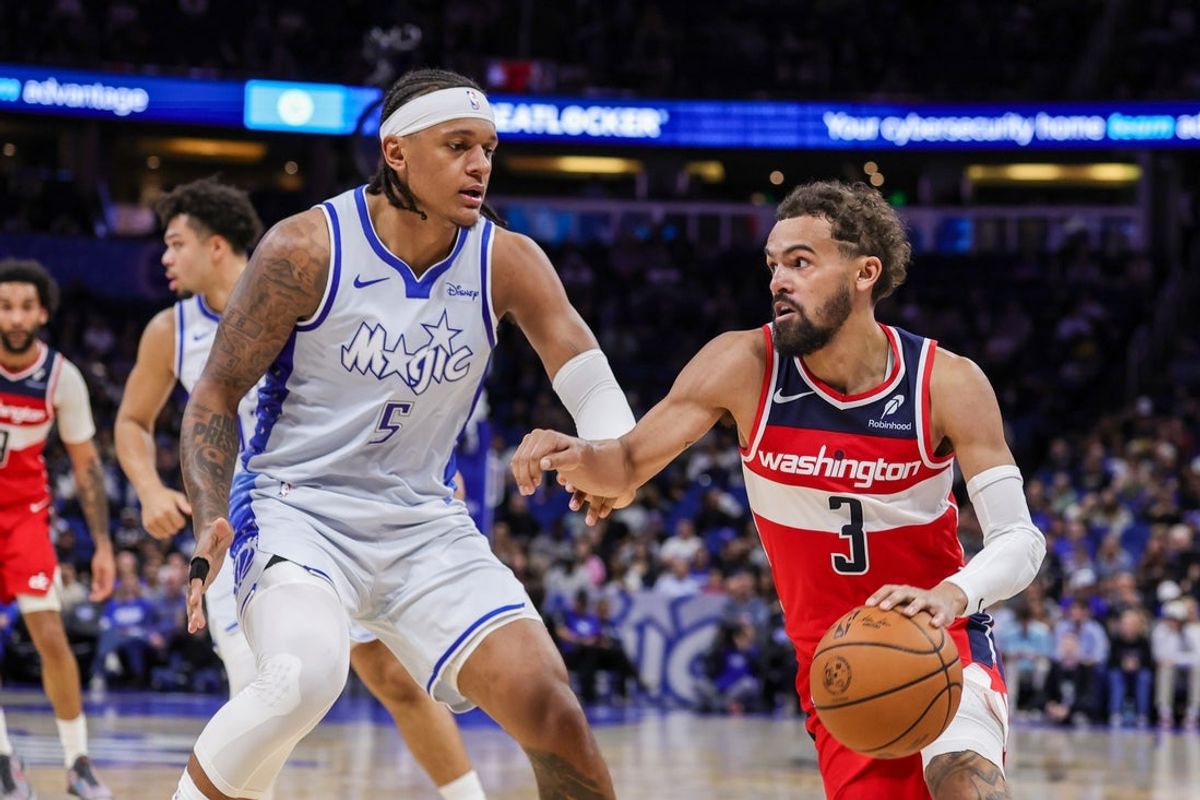 Mar 12, 2026; Orlando, Florida, USA; Washington Wizards guard Trae Young (3) drives against Orlando Magic forward Paolo Banchero (5) during the second quarter at Kia Center. Mandatory Credit: Mike Watters-Imagn Images