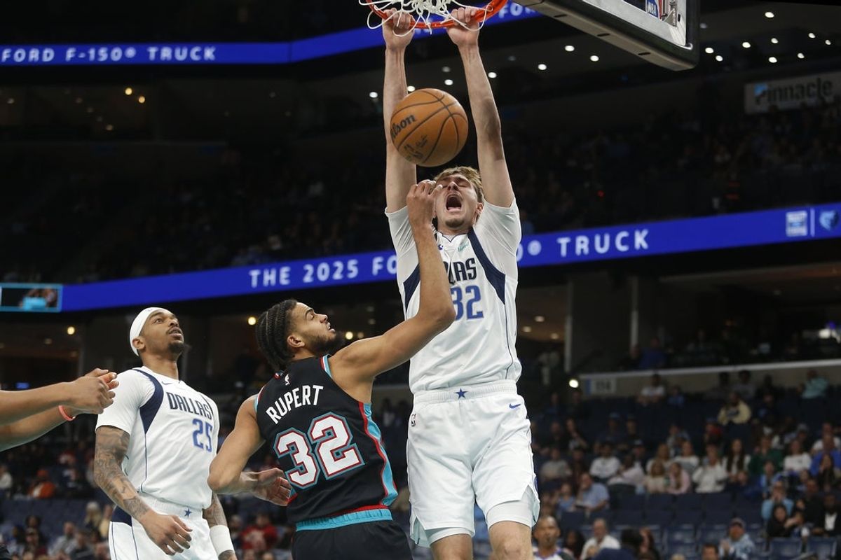 Mar 12, 2026; Memphis, Tennessee, USA; Dallas Mavericks forward Cooper Flagg (32) dunks over Memphis Grizzlies guard Rayan Rupert (32) during the first quarter at FedExForum. Mandatory Credit: Petre Thomas-Imagn Images