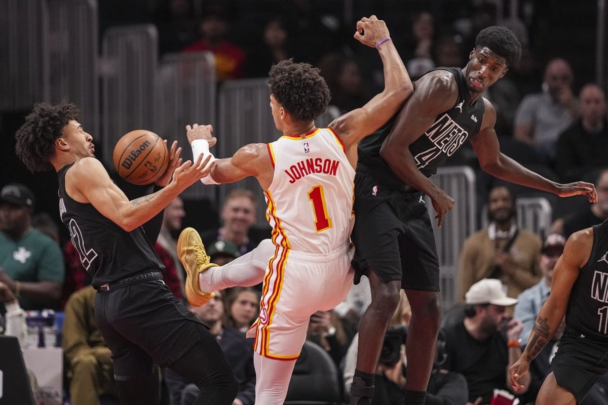 Mar 12, 2026; Atlanta, Georgia, USA; Brooklyn Nets forward Jalen Wilson (22) and guard Drake Powell (4) fight with Atlanta Hawks forward Jalen Johnson (1) for a rebound during the first half at State Farm Arena. Mandatory Credit: Dale Zanine-Imagn Images