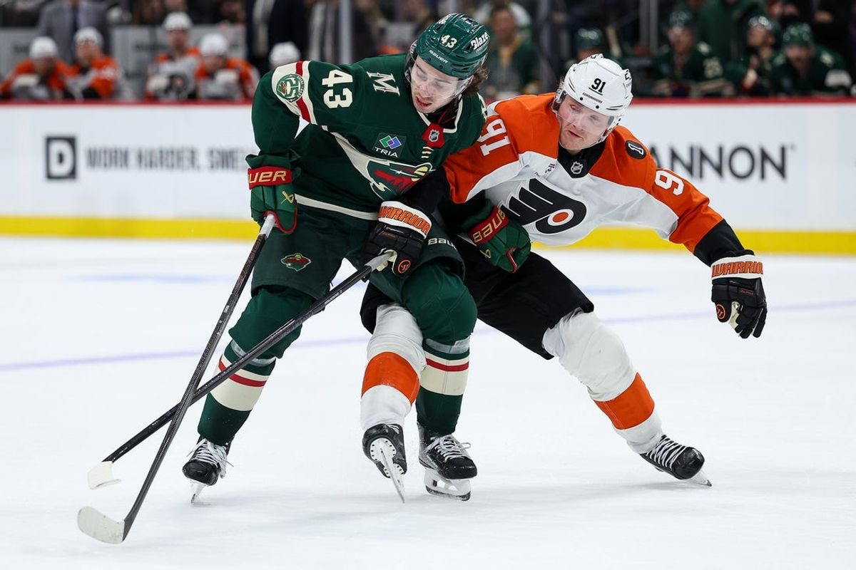 Mar 12, 2026; Saint Paul, Minnesota, USA; Minnesota Wild defenseman Quinn Hughes (43) and Philadelphia Flyers right wing Carl Grundstrom (91) compete for the puck during the second period at Grand Casino Arena. Mandatory Credit: Matt Krohn-Imagn Images