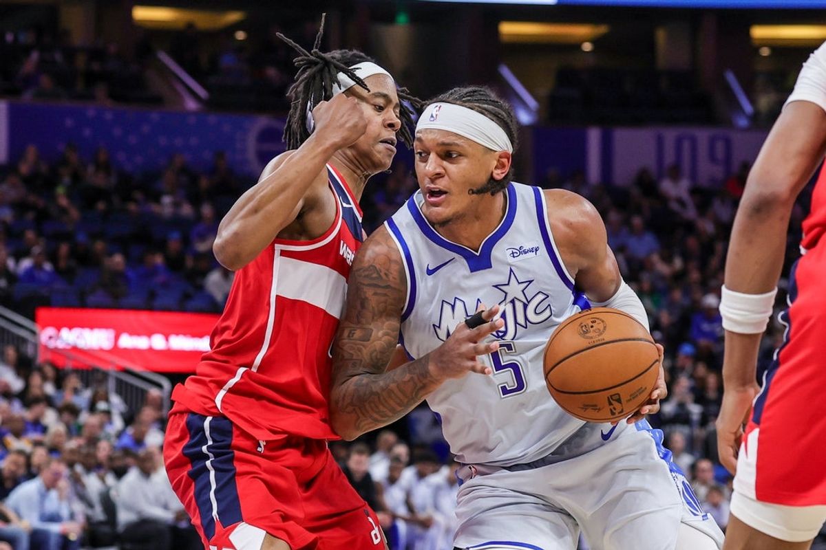 Mar 12, 2026; Orlando, Florida, USA; Orlando Magic forward Paolo Banchero (5) drives to the basket against Washington Wizards guard Tre Johnson (12) during the second half at Kia Center. Mandatory Credit: Mike Watters-Imagn Images