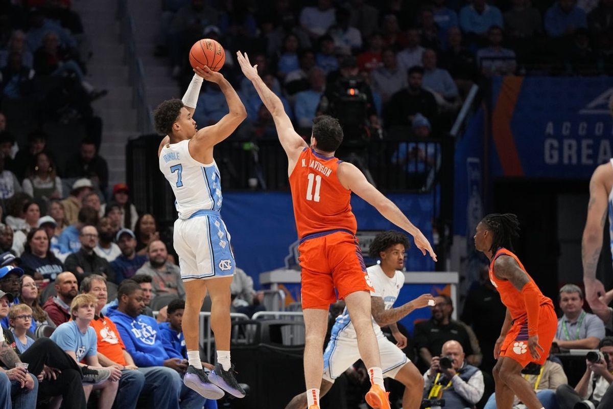 Mar 12, 2026; Charlotte, NC, USA; North Carolina Tar Heels guard Seth Trimble (7) shoots as Clemson Tigers forward Nick Davidson (11) defends in the first half at Spectrum Center. Mandatory Credit: Bob Donnan-Imagn Images