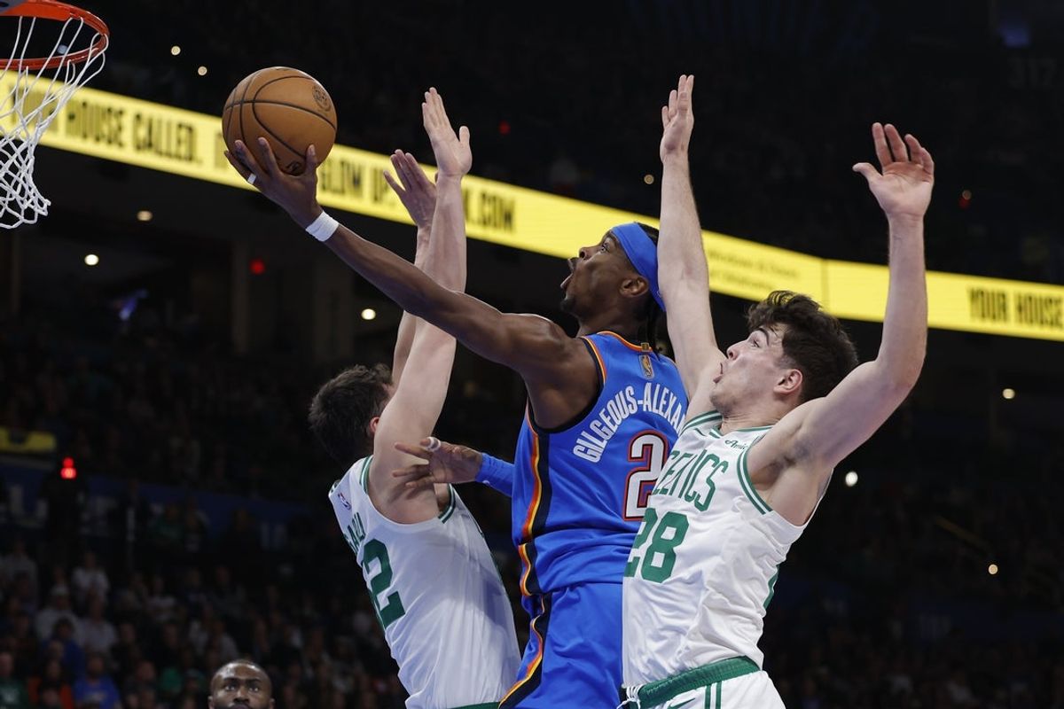 Mar 12, 2026; Oklahoma City, Oklahoma, USA; Oklahoma City Thunder guard Shai Gilgeous-Alexander (2) goes up for a basket between Boston Celtics center Luka Garza (52) and guard Hugo González (28) during the second quarter at Paycom Center. Mandatory Credit: Alonzo Adams-Imagn Images