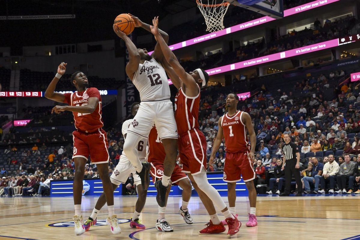 Mar 12, 2026; Nashville, TN, USA;  Texas A&M Aggies forward Rashaun Agee (12) shoots over Oklahoma Sooners forward Mohamed Wague (5) during the first half at Bridgestone Arena. Mandatory Credit: Steve Roberts-Imagn Images