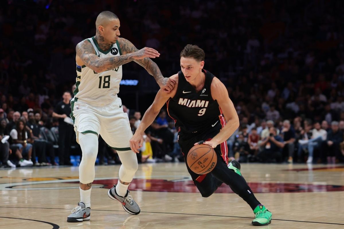 Mar 12, 2026; Miami, Florida, USA; Miami Heat guard Pelle Larsson (9) drives to the basket against Milwaukee Bucks forward Kyle Kuzma (18) during the fourth quarter at Kaseya Center. Mandatory Credit: Sam Navarro-Imagn Images