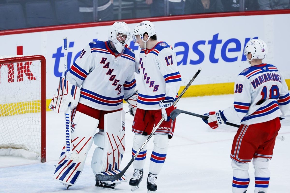 Mar 12, 2026; Winnipeg, Manitoba, CAN; New York Rangers goalie Igor Shesterkin (31) is congratulated by defenseman Will Borgen (17) on his win against the Winnipeg Jets at the end of the third period at Canada Life Centre. Mandatory Credit: Terrence Lee-Imagn Images